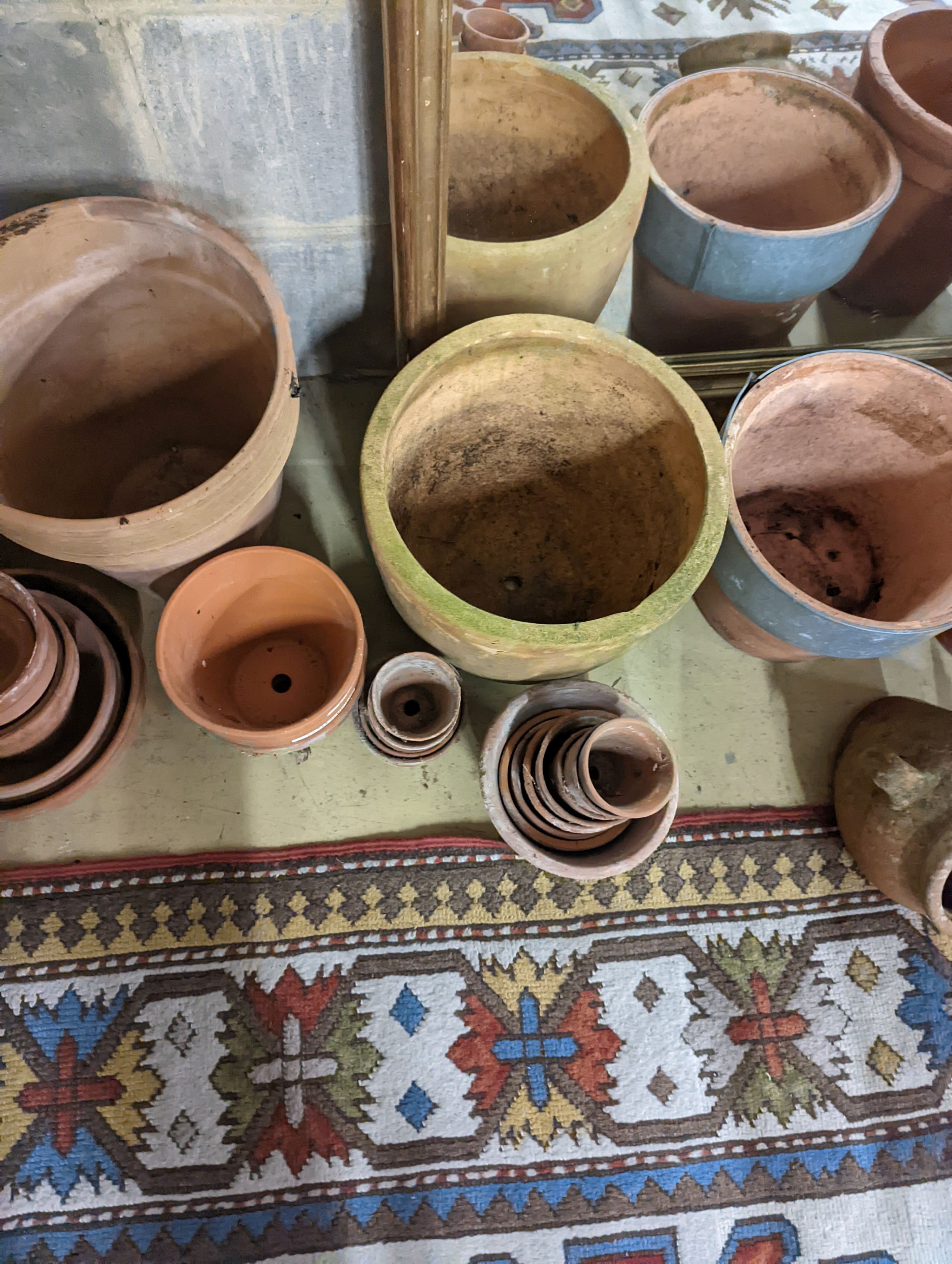 A collection of approximately 40 assorted terracotta planters, largest diameter 32cm